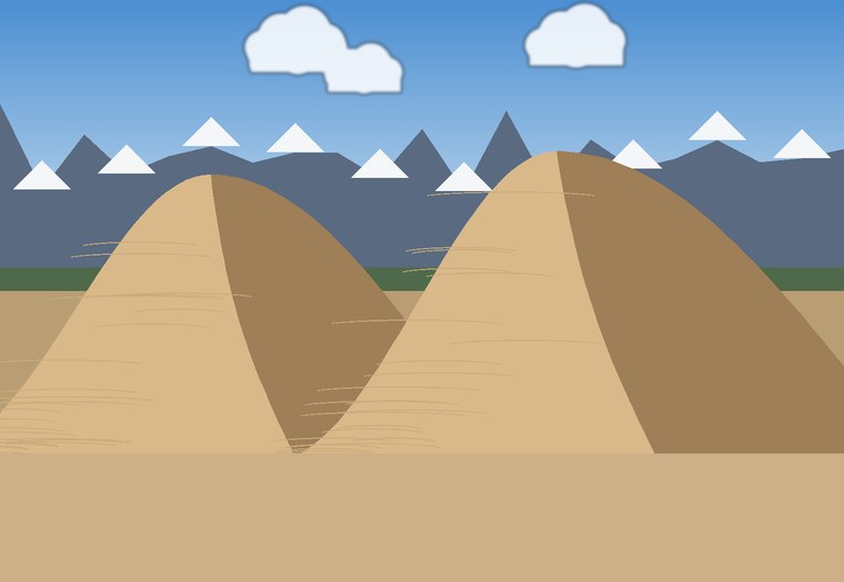 Sand dunes below snow-capped mountains in Colorado